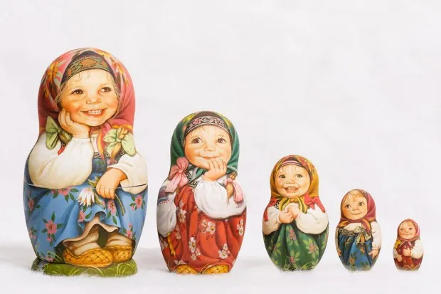 five nesting dolls with realistic faces