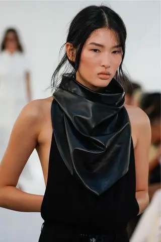 Model wearing bronzed cheeks, one of the key Spring/Summer 2025 fashion month beauty looks, on the Brandon Maxwell runway