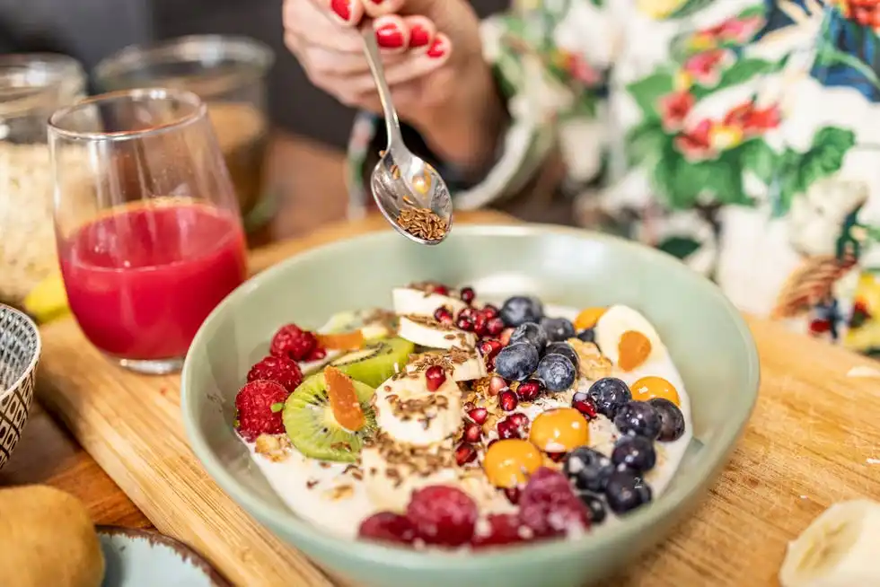 close up of healthy breakfast superfood bowl with yogurt and fruits