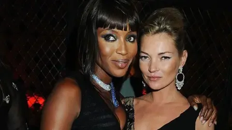 Getty Images Modelling stars Naomi Campbell and Kate Moss standing together