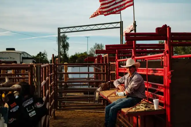 A young cowboy wraps his arm with medical tape at the Tuscarawas County Fair.