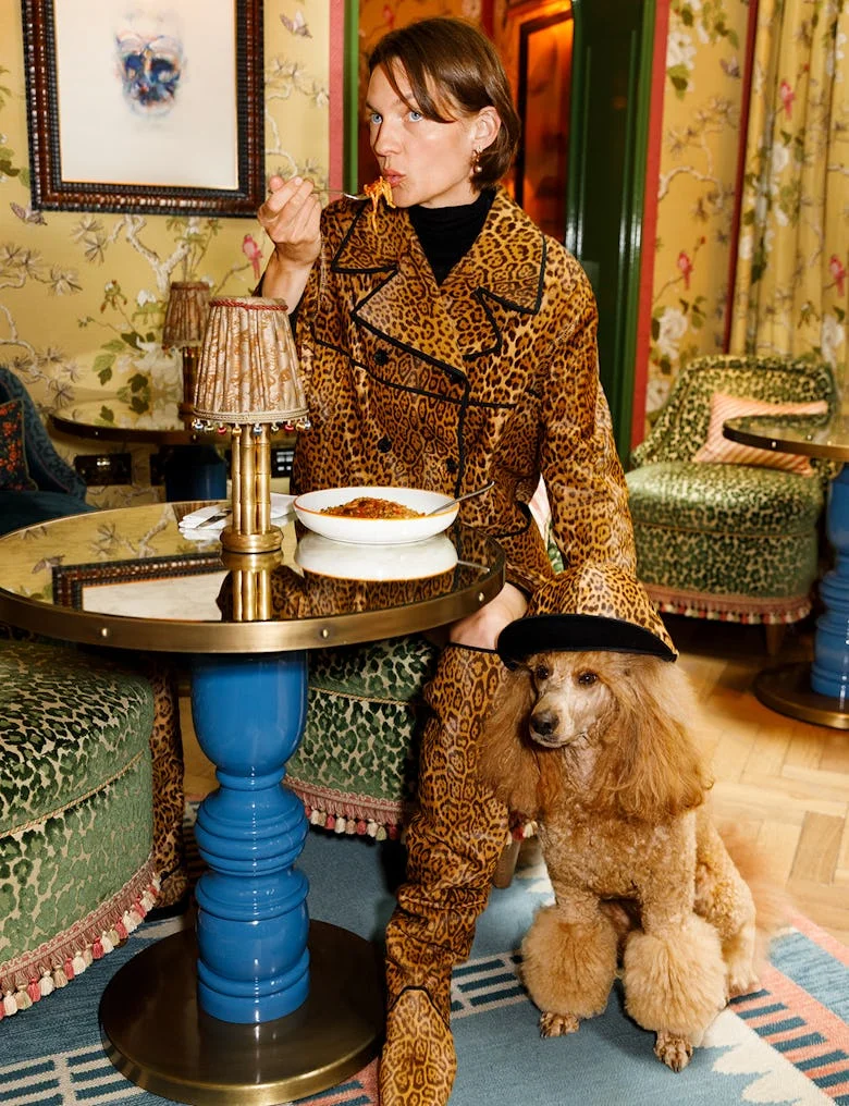 Woman in leopard coat with dog