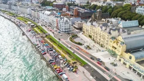 IOM FESTIVAL OF MOTORING An aerial view of Douglas Promenade with hundreds of colourful cars lined up on the seafront.