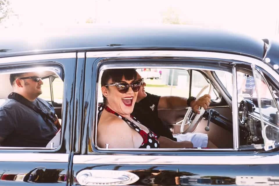 Pin-up Girl Riding with Two men in classic car Route 66 Cruisin'' Reunion