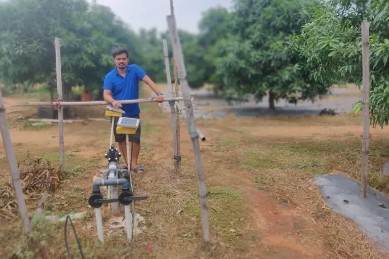 Binod Kumar Mahto stands next to the automatic irrigation system. Image by Vishal Kumar Jain.