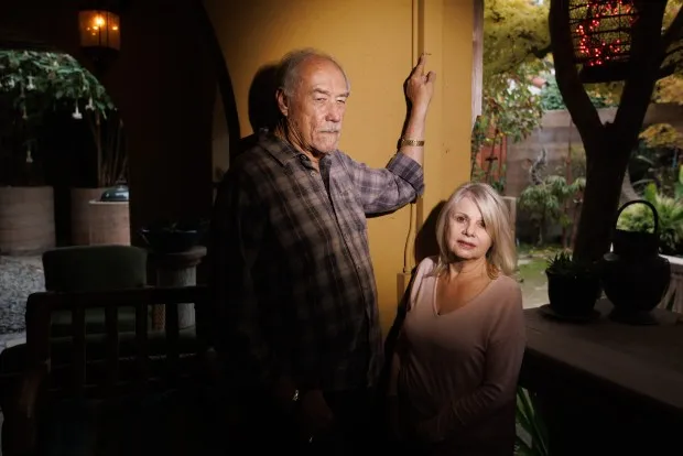 SAN JOSE, CA - November 18: Sandra Moll, right, and her husband, Rick Holden are photographed in their backyard on Thursday, Nov. 18, 2021 as Holden shows how high the 2017 Coyote Creek flood waters reached in their backyard, in San Jose, Calif.(Dai Sugano/Bay Area News Group)