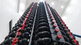 A large rack of satellites in a warehouse