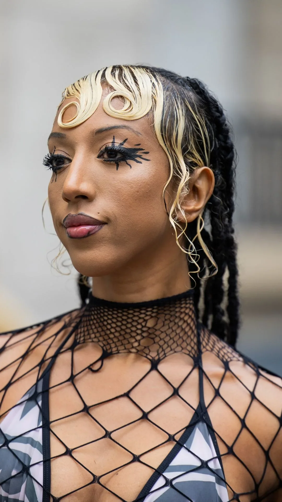 A guest wears net top, white skirt outside Ottolinger during Womenswear Spring/Summer 2025 as part of Paris Fashion Week on September 29, 2024 in Paris, France.