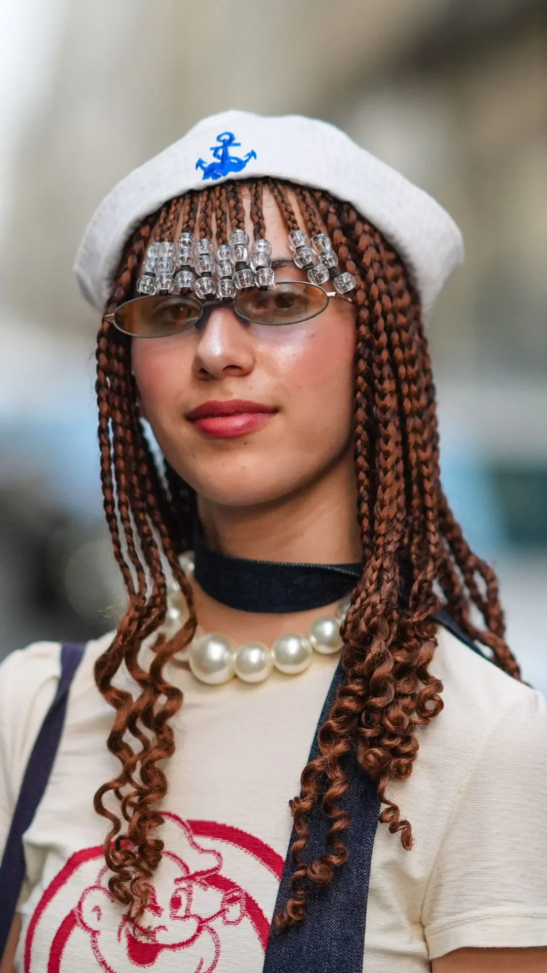 Caroline Takrarit wears a white sailor hat, bejeweled bangs, a Moschino t-shirt, outside Jean Paul Gaultier, during the Haute Couture Fall/Winter 2024/2025 as part of Paris Fashion Week on June 26, 2024 in Paris, France.