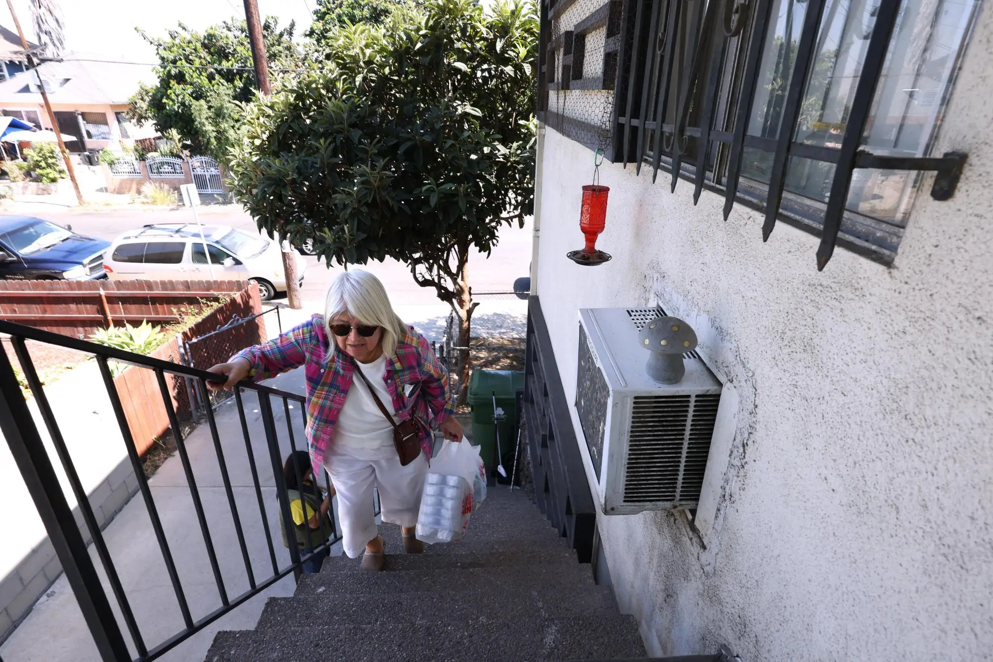 Setsuko Nakama walks up stairs to deliver a meal.