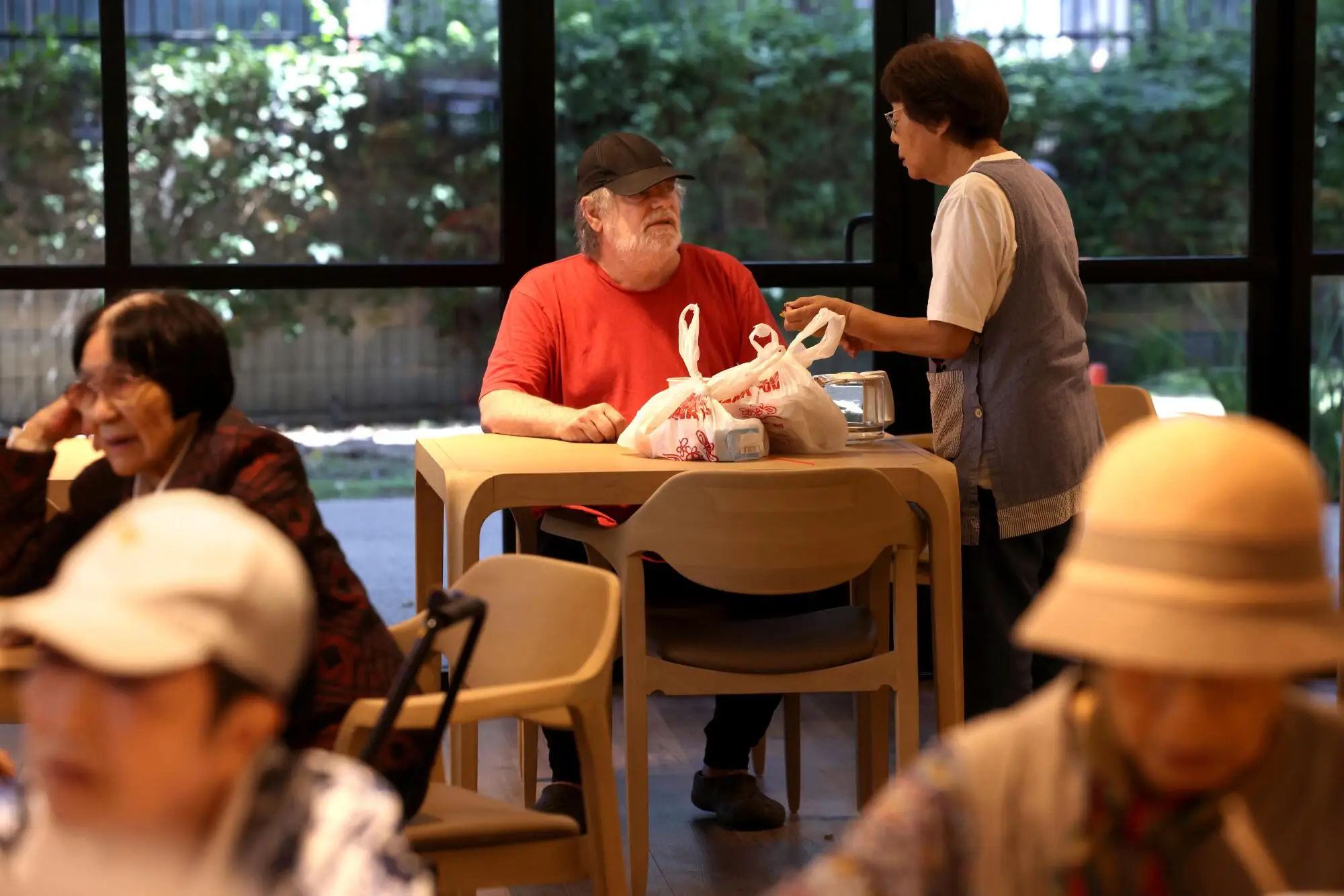 Richard Witsoe speaks with a volunteer after receiving his meal.