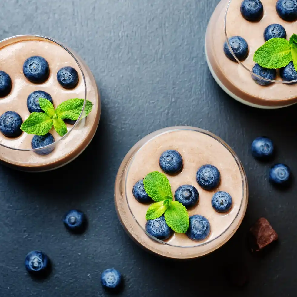 greek yogurt vanilla chocolate panna cotta with mint leaves and fresh blueberries