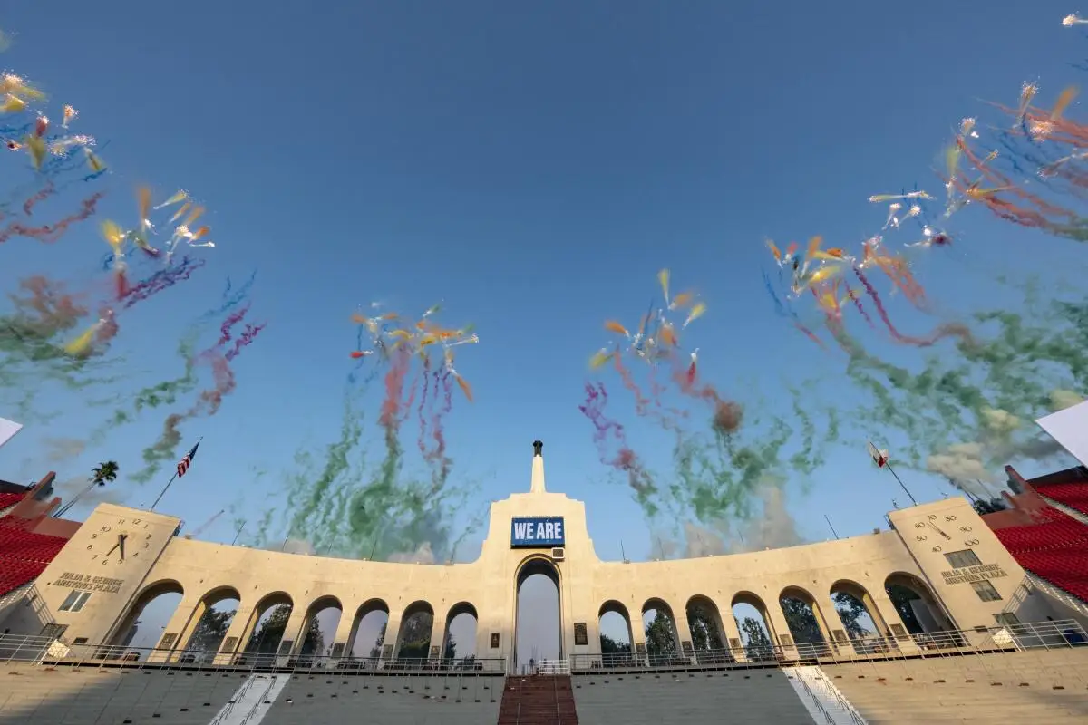 Colorful chalk-based fireworks explode over the L.A. Coliseum.