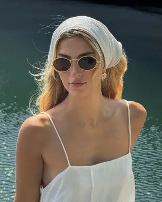 Cass Dimicco wears a white hair scarf with eyewear from the Aureum Collective