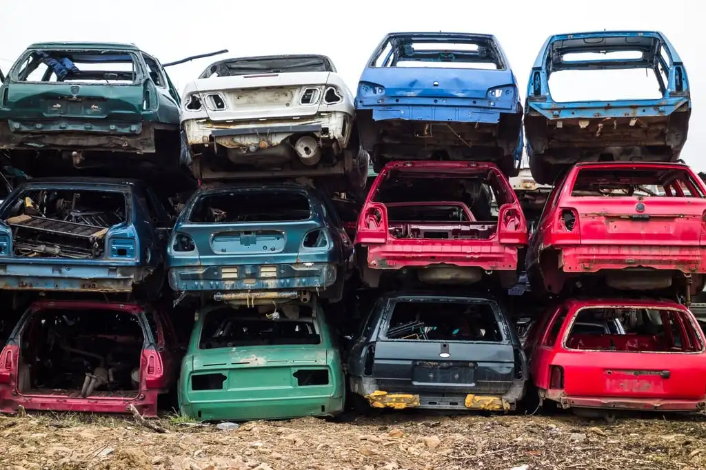 Car bodies stacked at a scrapyard. Recycling materials used in making cars is becoming increasingly important in the automotive industry. Photo: Shutterstock