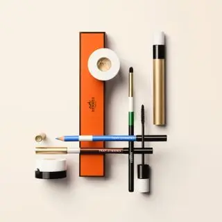 Hermès Beauty’s ‘Trait d’Hermès’ eye pencils and eye liner with an orange box, pencil sharpener, brush and mascara