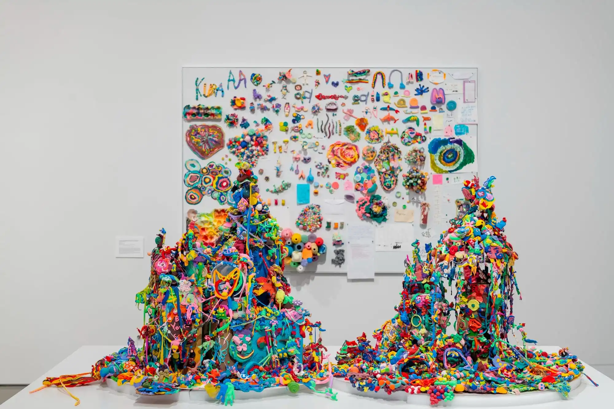 two mounds of colorful, stretchy material on a table with a similarly colorful backdrop