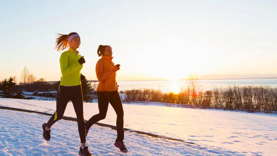  Two women running in the snow. 