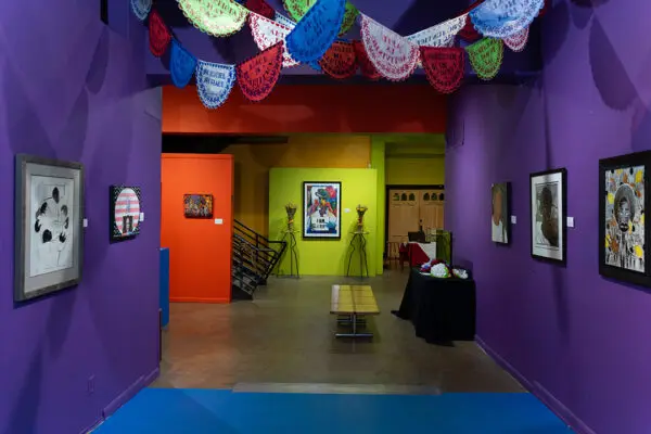 An installation photograph of an art exhibition featuring reflections on Elizabeth Catlett's work.