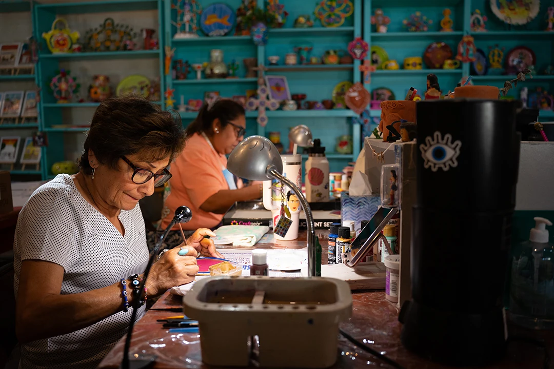 A photograph of two ceramicists working in a studio.