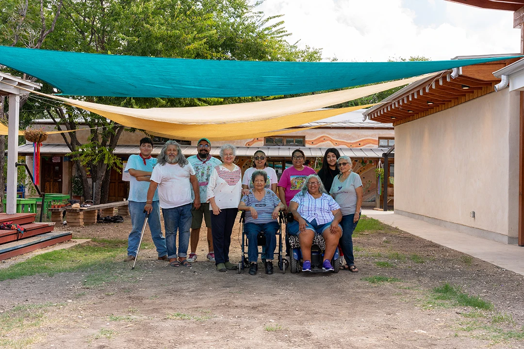 A photograph of ten volunteers and community members at Esperanza Peace & Justice Center.