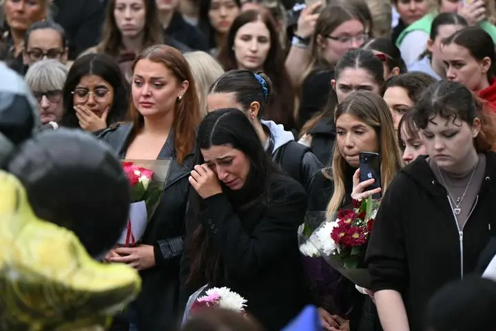 Fans of former One Direction singer Liam Payne observe a minute's silence during a gathering in London's Kensington Gardens. Payne died after falling from a third-floor hotel balcony in Buenos Aires, Argentina, on Wednesday.