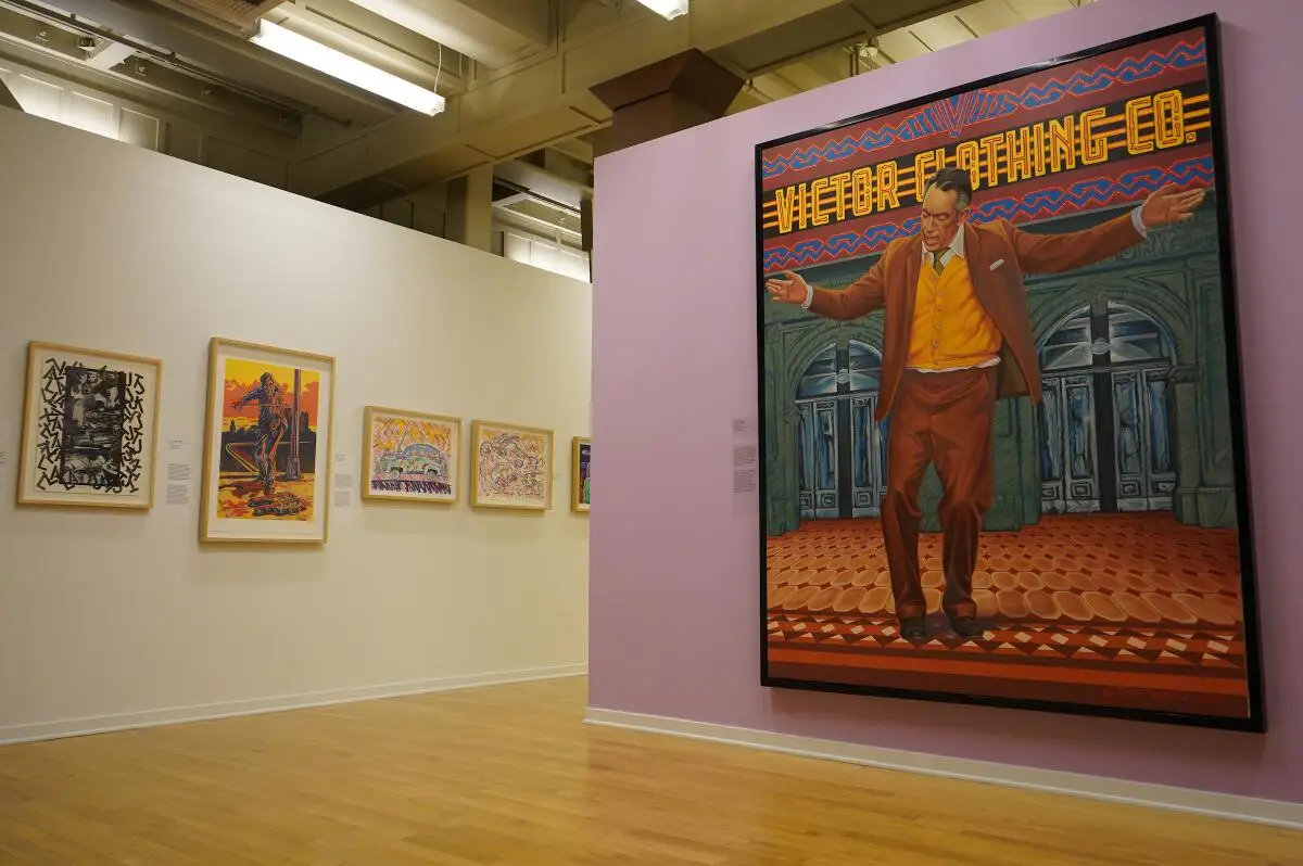 An installation view of a gallery shows a painting of Anthony Quinn by Eloy Torrez in the foreground