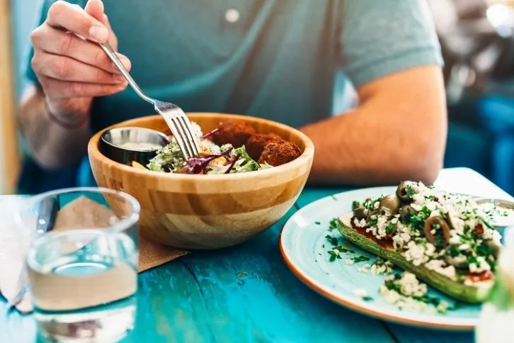 Personalsed nutrition - man eating salad - GettyImages-VioletaStoimenova