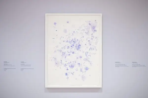 A painting with multiple purple splotches, markings and dots.