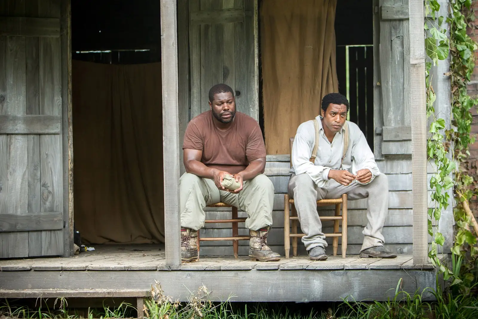 Image may contain Steve McQueen Solomon Northup Person Sitting Clothing Footwear Shoe Adult Chair and Furniture