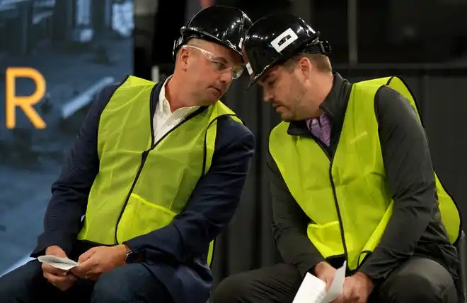 Mayor of Fishers Scott Fadness (left) whispers to Mitch List, general manager of Fishers Event Center, (right) during a press conference as construction continues Thursday, Oct. 24, 2024, at Fishers Event Center in Fishers, Ind. The new venue opens next month and will feature sporting and entertainment events.