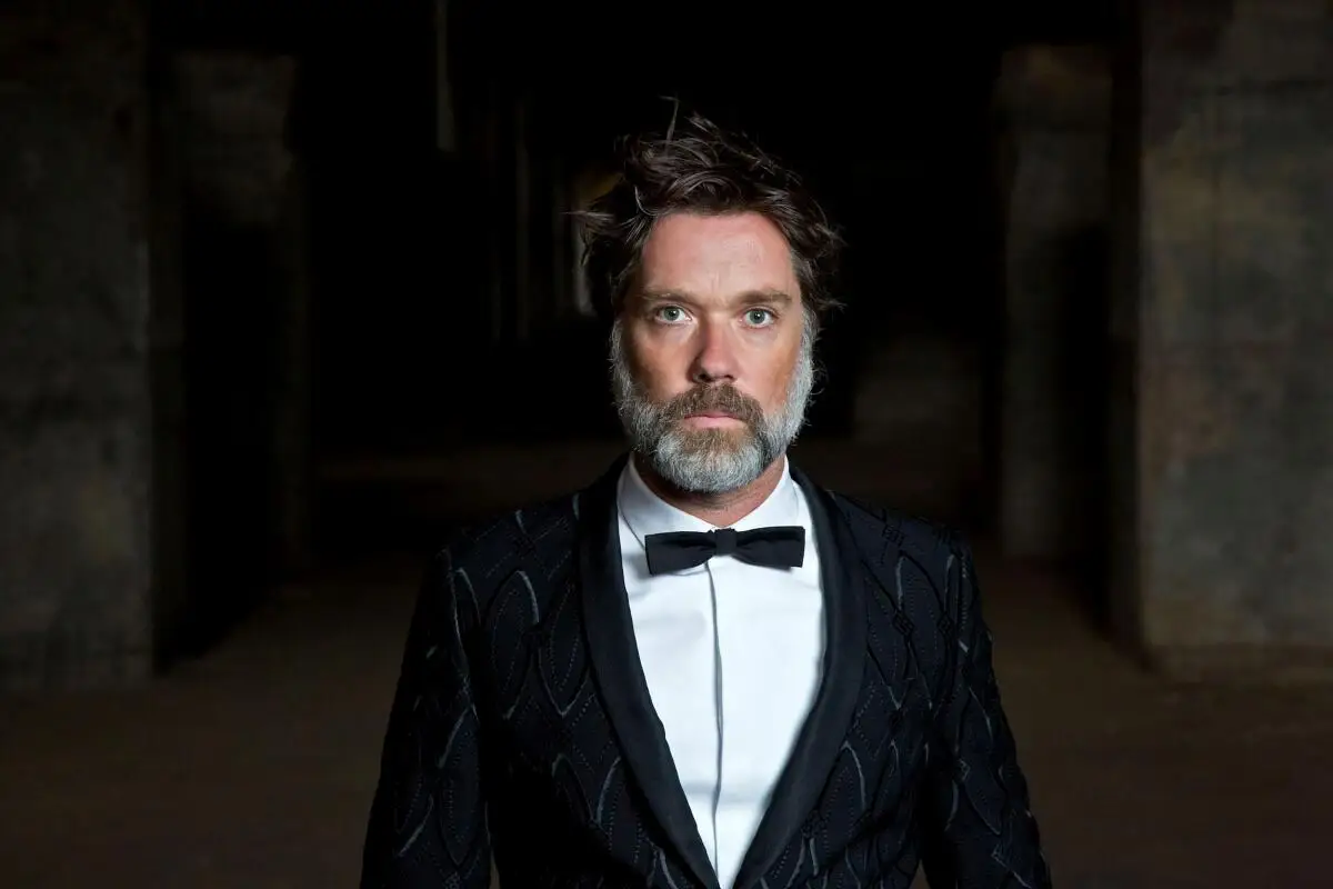 Bearded musician Rufus Wainwright in a tuxedo.