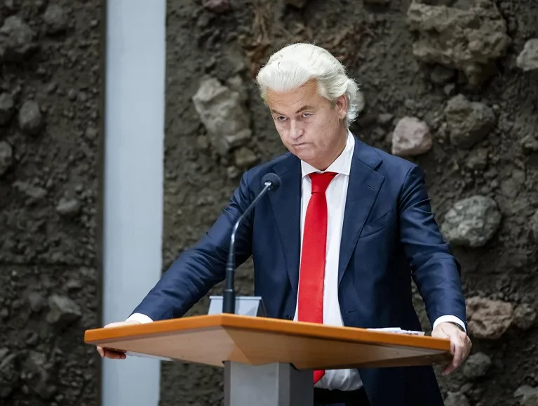 Geert Wilders speaks at a podium during the weekly question time in the House of Representatives in The Hague, the Netherlands.