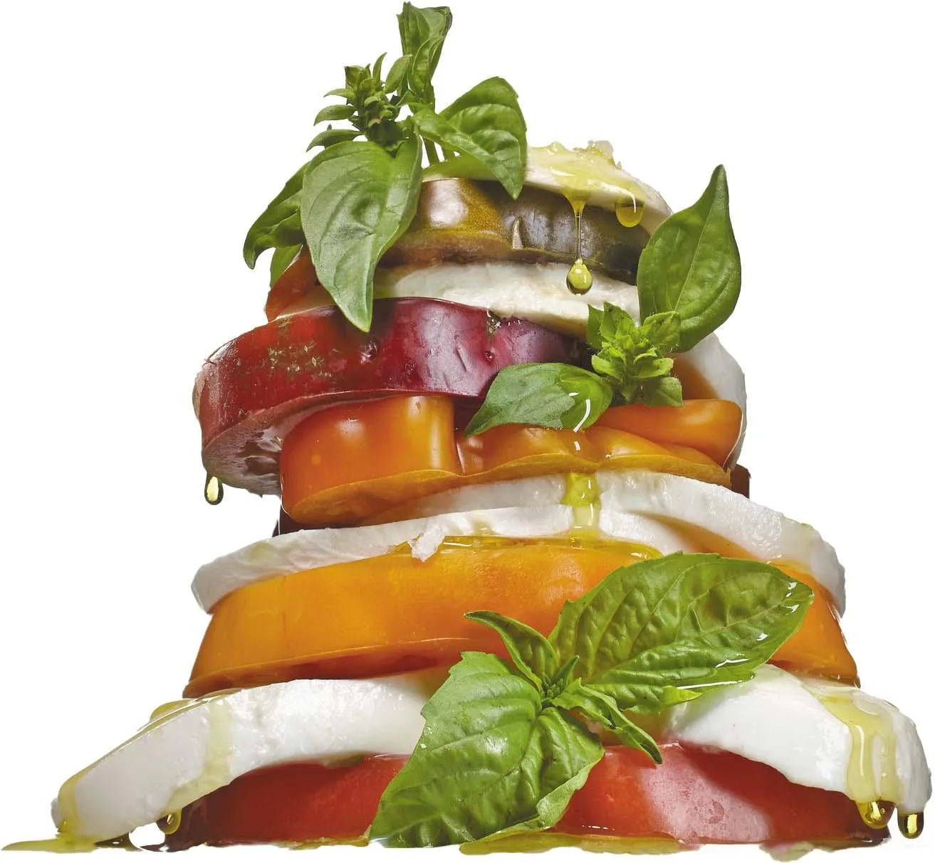 A stack of tomato slices alternating with onion and basil, with olive oil drizzled over all of it.