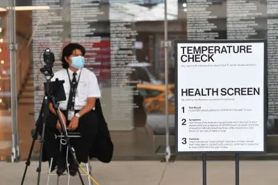 An employee sits at a temperature check stand at the newly reopened Whitney Museum of American Art on September 3, 2020 in New York City. - The museum officially opened to the public with new safety guidelines after being closed for months due to covid-19. (Photo by Angela Weiss / AFP) (Photo by ANGELA WEISS/AFP via Getty Images)