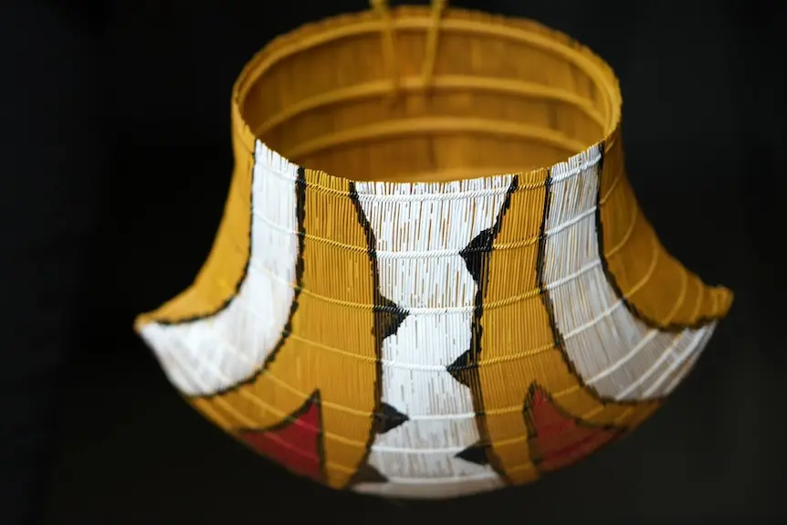 A colourful basket sits in an art gallery.