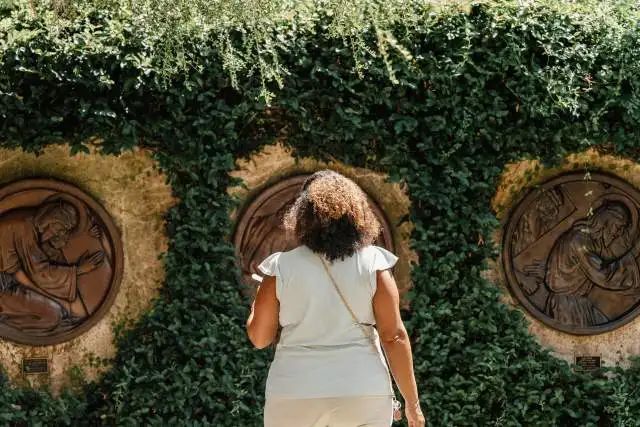 A woman views outdoor sculpture at the Albin Polasek Museum & Sculpture Gardens.