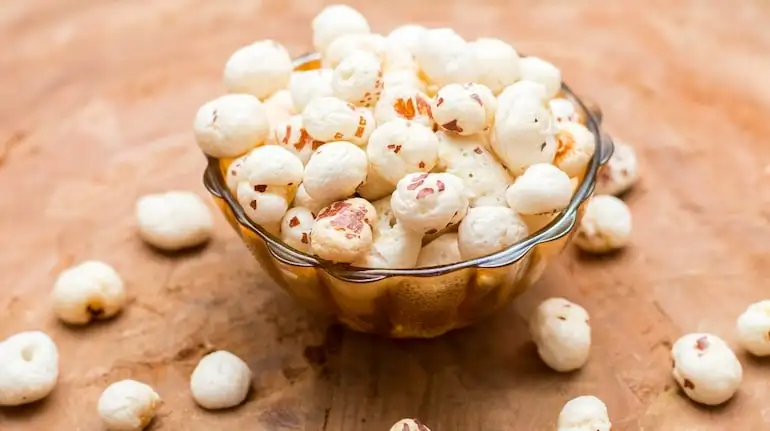 Health benefits of makhana: After indulging in sweets, swap sugary treats for nutrient-rich snacks like roasted nuts and seeds, homemade oat-and-date energy bites, fruit-and-nut bars, or makhana (fox nut) snacks (Image: Canva)