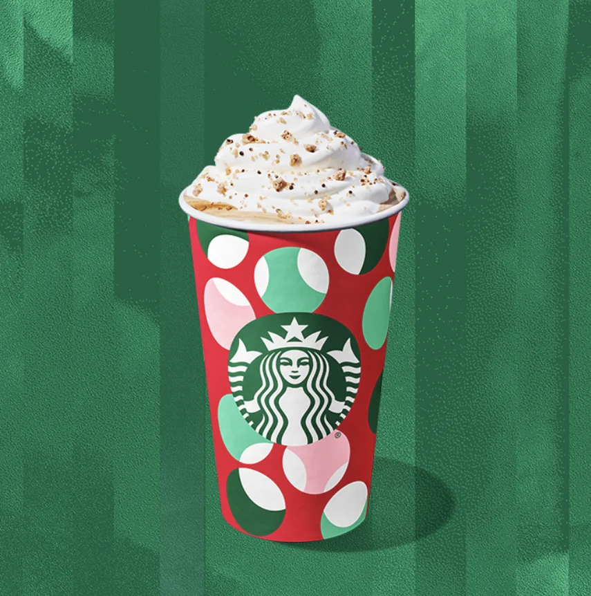 The Chestnut Praline Latte comes with whipped cream and a spiced sugar topping.