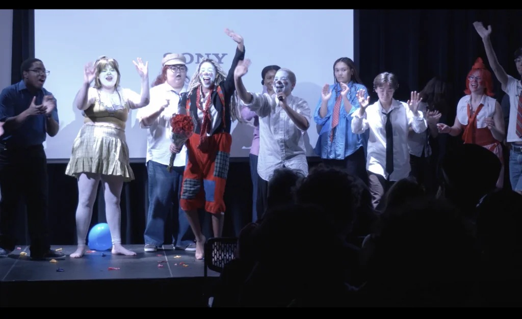 A group of people dressed as clowns on stage