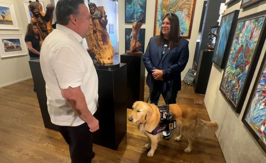 Artist Ruben Chato Hinojosa, known as Artist Chato, is shown speaking with KPBS reporter John Carroll at EC Gallery on November 7, 2024.