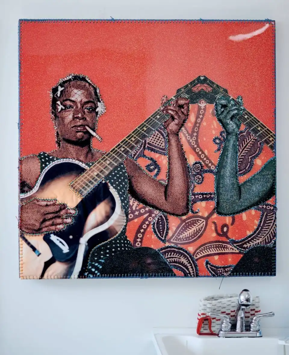 a tapestry of a black woman playing guitar and smoking a cigarette. a fragmented figure in blue mirrors her pose