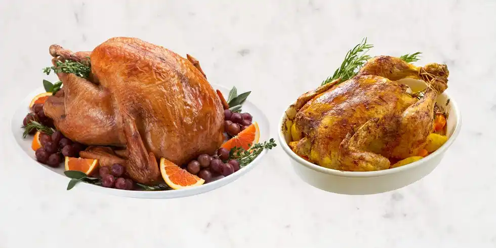 two roasted turkeys presented on platters with garnishes