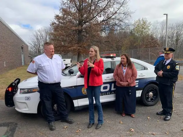 Scranton donated a 2015 Ford Taurus Interceptor police car to the Career Technology Center of Lackawanna County for education in the high school's Protective Services Program. The city delivered the vehicle to the school in Scranton on Friday, Nov. 15, 2014. Scranton Mayor Paige Gebhardt Cognetti, second from left, speaks during the event, flanked by CTC Protective Services Instructor Jonathan Coyne, at far left, and CTC Director Karla Carlucci, third from left, and Scranton Police Chief Thomas Carroll, at far right. JIM LOCKWOOD / STAFF PHOTO