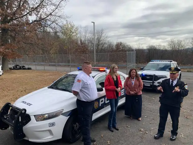 Scranton donated a 2015 Ford Taurus Interceptor police car to the Career Technology Center of Lackawanna County for education in the high school's Protective Services Program. The city delivered the vehicle to the school in Scranton on Friday, Nov. 15, 2014. Scranton Police Chief Thomas Carroll, at right, speaks. The others, from left, are CTC Protective Services Instructor Jonathan Coyne, Scranton Mayor Paige Gebhardt Cognetti and CTC Director Karla Carlucci. JIM LOCKWOOD / STAFF PHOTO