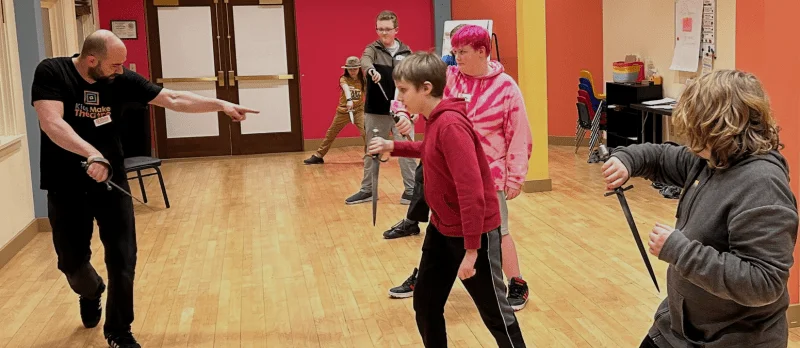 Sam Dinkowitz (left) teaches an intermediate stage combat class last spring at Kids Make Theatre. Photo courtesy: Kids Make Theatre