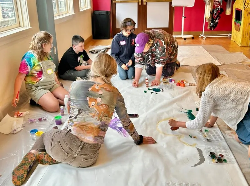 Participants in last summer’s production camp of “Peter Pan” at Kids Make Theatre in Astoria paint a backdrop for the performance. Campers learned and practiced technique and design, acting, and the ensemble creation of theater stories. Photo courtesy: Kids Make Theatre