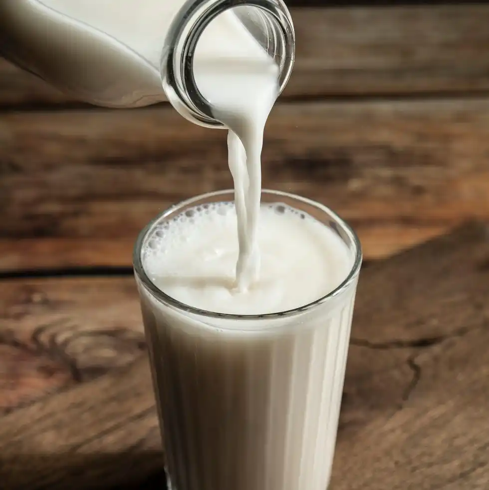 close up of milk pouring in drinking glass on table,turkey