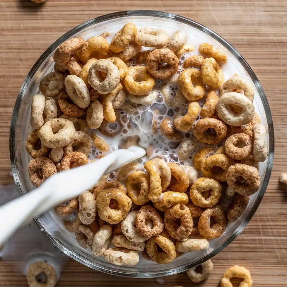 directly above shot of milk pouring in breakfast served on table