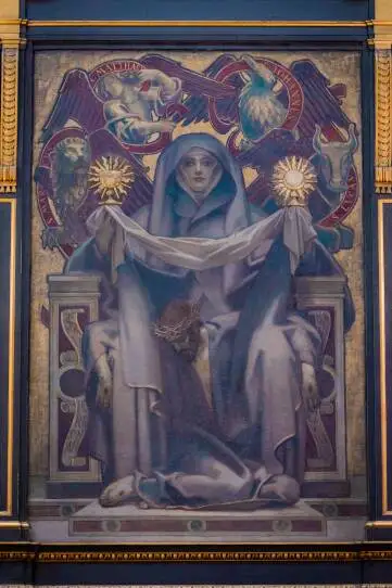 An elaborate painting in blue, lavendar and gold hues shows a hooded and cloaked figure staring at the viewer and holding two gold items while the image of a downtrodden Christ with a crown of thorns and red wounds on his hands is supported by the figure.